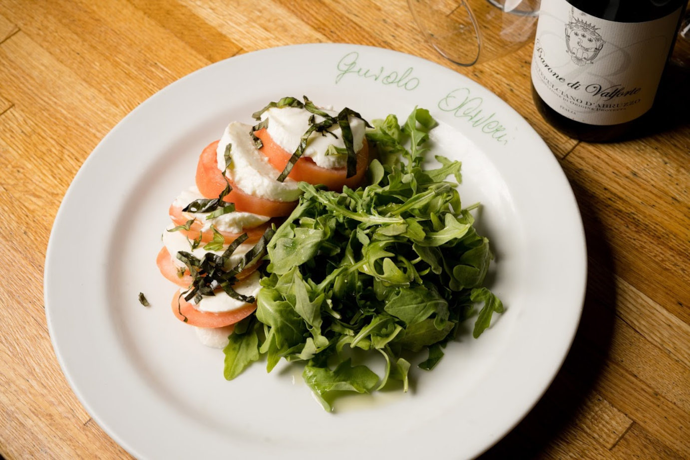 Capreze with mozzarella, tomatoes and greens